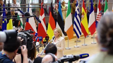 Prime-Minister-of-Italy-Giorgia-Meloni-talking-to-the-press-during-the-European-Council-summit-in-Brussels,-Belgium---Wide-angle-shot