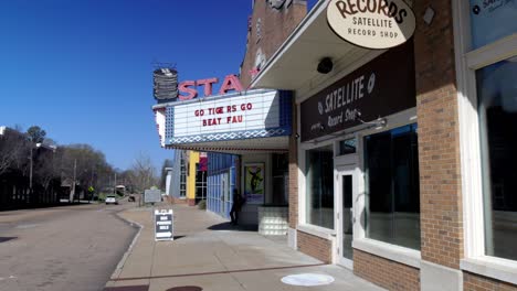 Stax-Museum-of-American-Soul-Music-sign-in-Memphis,-Tennessee-with-gimbal-video-walking-from-the-side-in-slow-motion