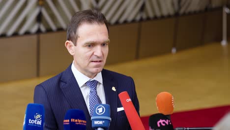 Prime-Minister-of-Slovakia-Ľudovít-Ódor-giving-an-interview-during-the-European-Council-summit-in-Brussels,-Belgium---Close-shot
