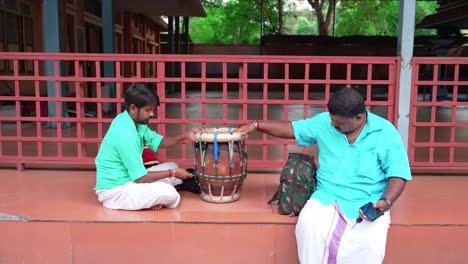 South-Indian-musicians-use-wrench-while-adjusting-on-Thavil-at-the-temple