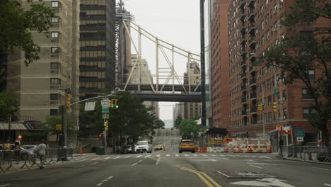 Upper-East-Side-Street-In-New-York-City-With-Queensboro-Bridge-Passing-Overhead