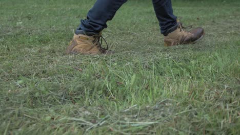 A-man-wearing-boots-walking-across-a-freshly-cut-field