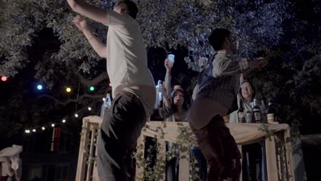 Revealing-shot-of-a-group-of-drunk-friends-drinking-with-males-twerking