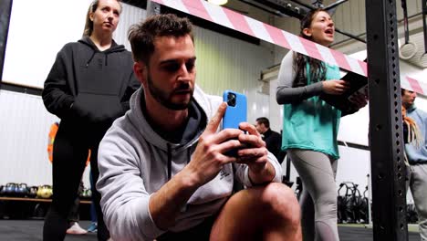 A-man-captures-on-his-phone-as-someone-practices-or-competes-in-sports