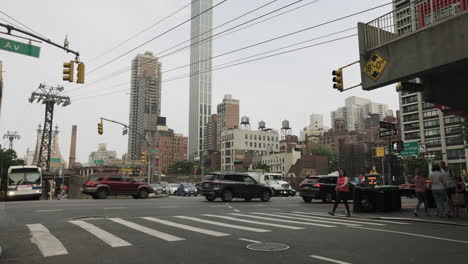 Busy-New-York-City-Intersection-With-Roosevelt-Island-Tramway-Passing-Over-Street
