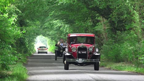 Vintage-classic-car-driving-down-a-leafy-Irish-lane-in-Co-Kildare-at-speed