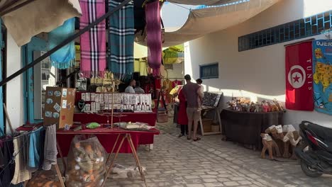Shopping-at-traditional-shops-of-colorful-Houmt-El-Souk-market-in-Djerba,-Tunisia