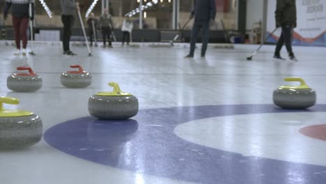 Curling-stone-sliding-past-other-stones