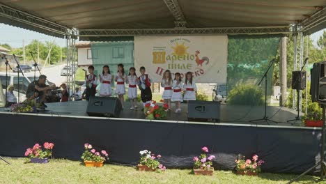 Young-children-in-Bulgarian-dress-perform-on-summer-festival-stage