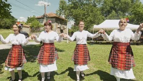 Dance-group-in-traditional-costume-perform-on-grass-at-summer-festival