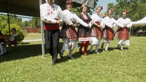 Happy-people-dancing-Horo-at-cultural-event-in-traditional-dress-Bulgaria