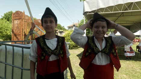 Two-happy-smiling-boys-in-traditional-Bulgarian-dress-and-kalpak-hats