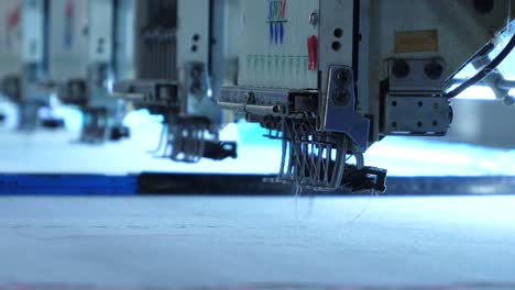 Close-Up-Of-Sewing-Needles-On-Automated-Fabric-Stitching-Machines-At-Garment-Factory-In-Karachi