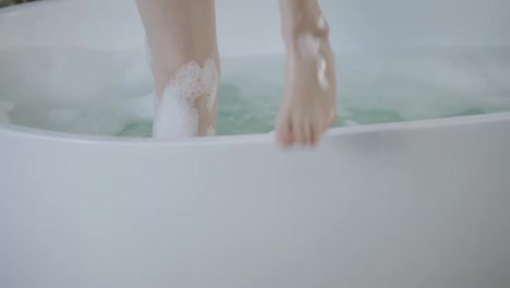Close-Up-woman's-walking-legs-with-foam-after-bath