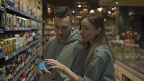 Couple-in-the-grocery-store.-The-girl-and-her-boyfriend-chooses-what-she-wants-to-buy.-Daily