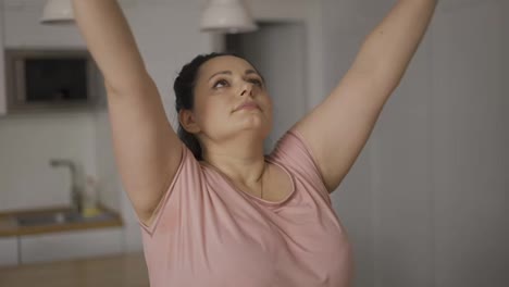 Young-attractive-plus-size-woman-practicing-yoga,-hold-hands-in-namaste