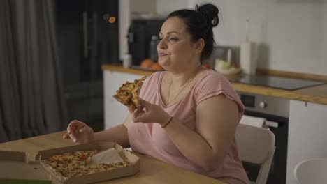 Overweighted-woman-eats-with-great-pleasure,-woman-eats-pizza,-rolls-eyes