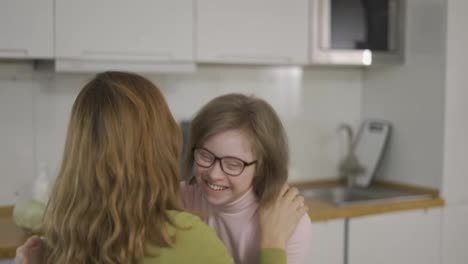 Sweet-down-syndrome-daughter-hugging-with-her-mom