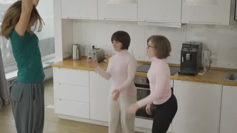 Young-girls-with-down-syndrome-are-dancing-and-rejoicing-with-her-mother-at-home