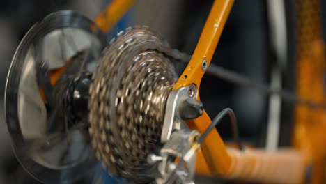 Rotating-bicycle-chain-and-gears-to-test-bicycle.-Cycling-workshop,-close-up
