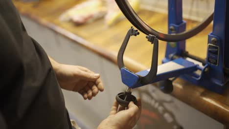 Wheel-straightening-stand-in-bicycle-workshop.Truing-bike-wheel