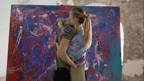 Couple-in-love-hugging-standing-in-front-large-canvas-all-in-paints