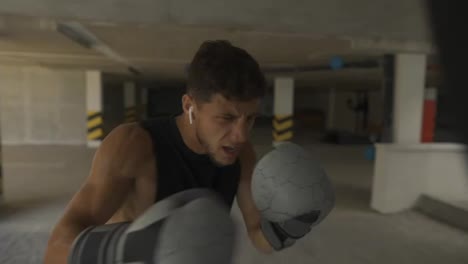 The-man-executes-strong-blows-in-the-boxing-bag,-accelerate-speed-footage