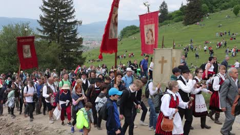 People-on-Csiksomlyo-Pilgrimage,-some-in-costume,-walking-to-mountain-saddle