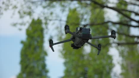 View-Of-DJI-Mavic-3E-Hovering-With-Bokeh-Background-In-Park