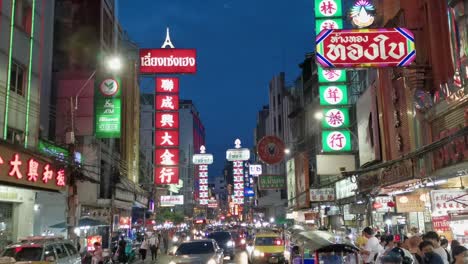Chinatown-in-the-Early-Evening-with-Illuminated-Lights-Along-Yaowarat-Road-with-Traffic-and-Tourists