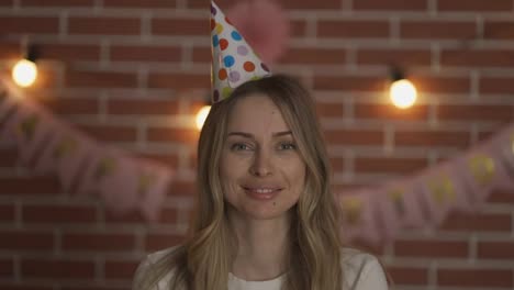 Portrait-of-a-birthday-woman-with-a-cap-on-her-head