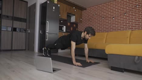 Man-doing-push-up-at-home-live-master-class-via-laptop