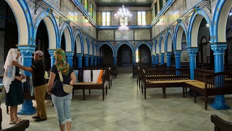 Headscarf-on-woman-at-entrance-of-El-Ghriba-Jewish-synagogue-of-Djerba-in-Tunisia