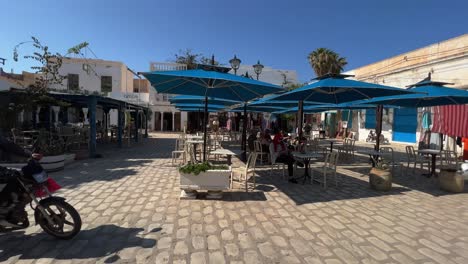 Tourism-at-Houmt-El-Souk-market-on-sunny-summer-day-in-Djerba,-Tunisia