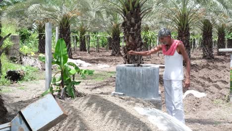 Farmer-showing-biogas-plant-with-natural-waste-in-his-horticulture-farm