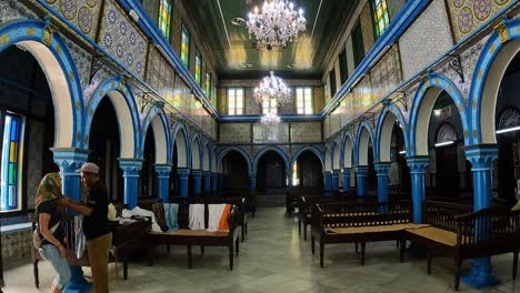 Headscarf-on-tourist-head-at-entrance-of-El-Ghriba-Jewish-amazing-synagogue-of-Djerba-in-Tunisia