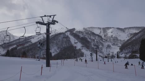 The-camera-captures-a-breathtaking-shot-of-Hakuba's-renowned-ski-resort,-with-its-bustling-ski-lift-system-and-a-vibrant-atmosphere,-offering-an-exhilarating-winter-experience-during-the-day