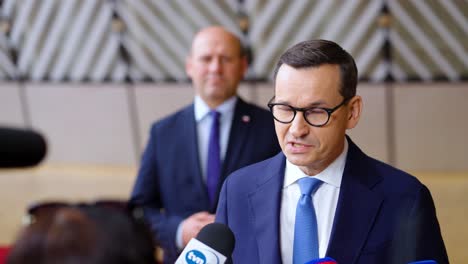 Polish-Prime-Minister-Mateusz-Morawiecki-talking-to-the-press-during-the-European-Council-summit-in-Brussels,-Belgium---Slow-motion-shot