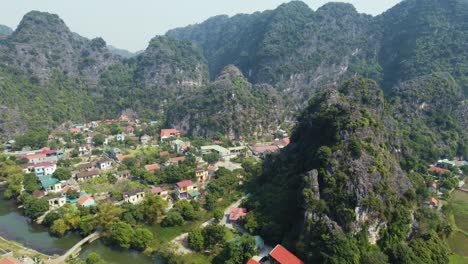 Aerial-Drone-Zooming-out-from-a-Big-Limestone-Mountain-with-A-Dragon-Temple-in-Vietnam