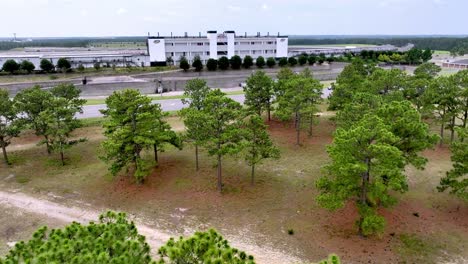 aerial-slow-push-toward-rockingham-speedway-over-the-pine-trees