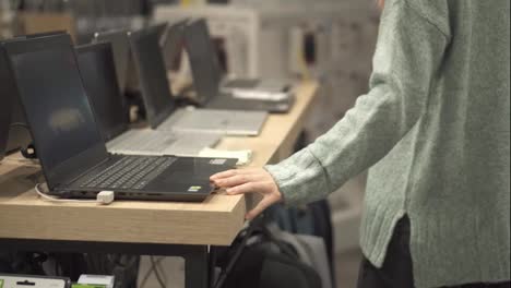 Woman-chooses-a-laptop-in-a-device-store