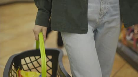 Cropped-of-young-woman-with-shopping-basket-in-supermarket