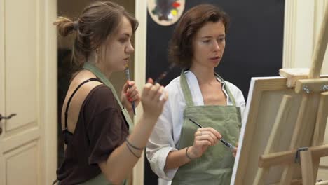 Student-and-art-teacher-during-painting-lesson
