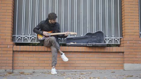 The-guy-playing-on-the-guitar-outdoor