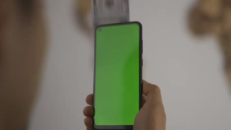 Cash-is-flying-out-of-the-phone-with-green-screen