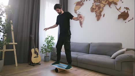 A-man-holds-a-balance-on-the-board-and-pipe-at-his-living-room