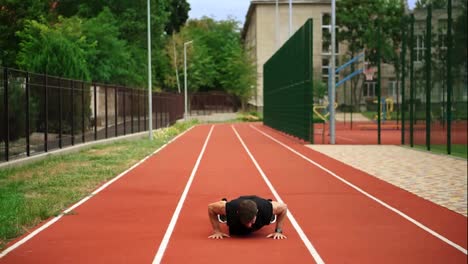 Fit,-bearded-man-standing-on-running-track-outdoors-on-modern-stadium-doing-workout