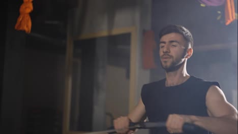 Bearded-man-training-in-gym-with-rowing-machine