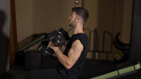 Muscular-male-athlete-workout-with-dumbbells,-lifting-up-weights,-close-up