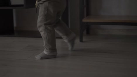 Cropped-footage-of-toddler-boy-running-around-at-home